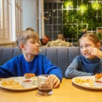 kids sharing fun meal in family restaurant